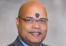 Dr. Braulio Cabral headshot picture on a gray background