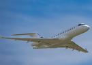 Leidos' white Bombardier 6500 jet aircraft pictured in the air