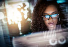 Women looking at monitor with reflection in her glasses