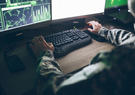 Military man working at a computer