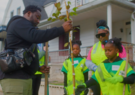 Adults and children planting a tree