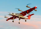 A white and orange hybrid-electric vertical take-off and landing cargo aircraft called Chaparral.