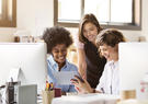 three women looking at tablet
