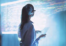 Female engineer looks at computer