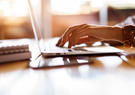 Woman typing on laptop at a cafe