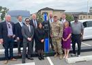 group of people in front of electric vehicle charging station