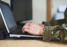 a soldier using a laptop