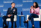 two people talking seated on a stage