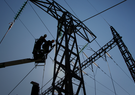two utility workers fixing power lines