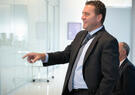 candid photo of man pointing at white board