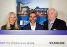 three people holding a check
