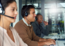 Employees taking calls at a military health contact center