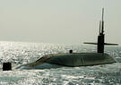 A submarine emerges from the ocean.
