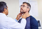 A male medical provider examines a male patient.