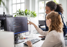 two women looking at computer screen