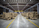 Multiple launchers are lined up in a warehouse.