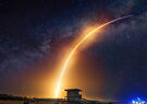 A rocket leaves a fiery trail in the sky.