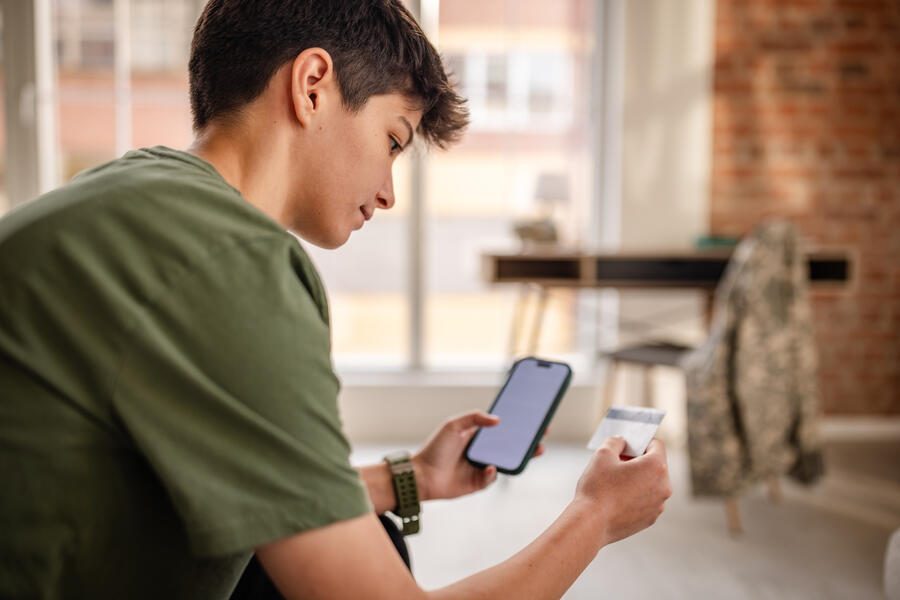 young soldier uses cell phone