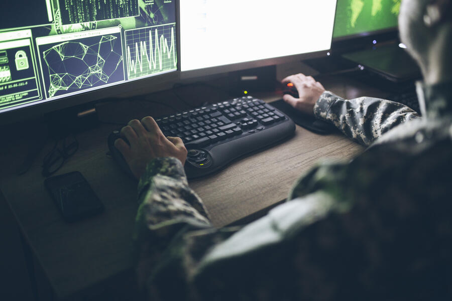 Offensive cyber operator sits at their desk