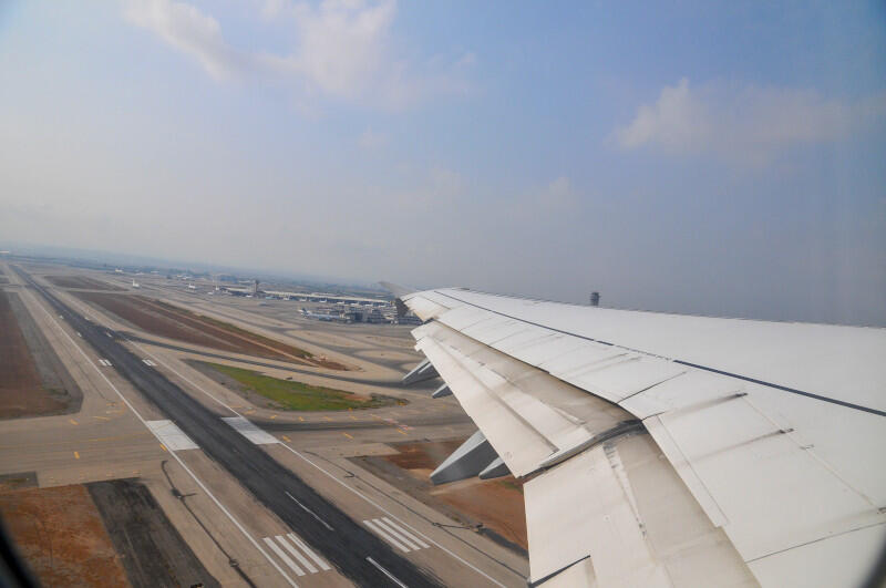 View out the window from passenger seat inside an airliner as it takes off
