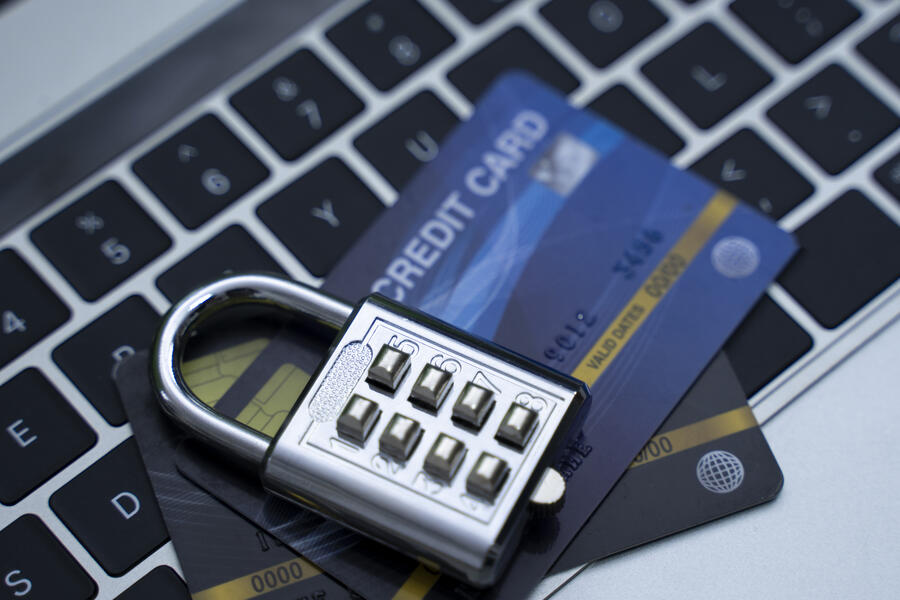 Credit card with a lock both sitting on top of a keyboard