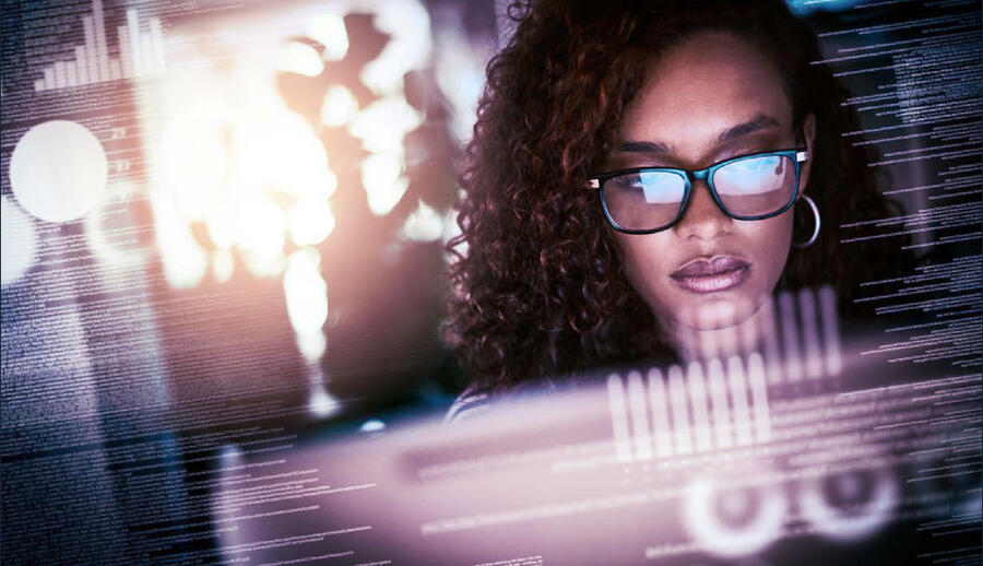 Woman working in front of a computer screen