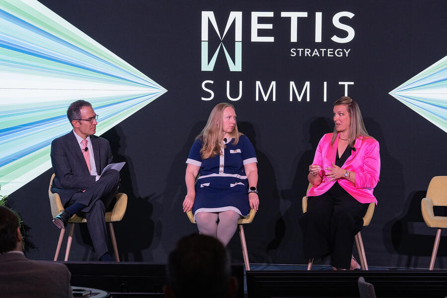 A panel of speakers participates in a discussion at the Metis Strategy Summit, sharing insights on leadership and technology strategy.