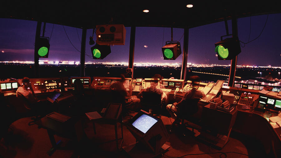 Air traffic controllers in tower at night