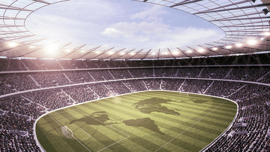 Overhead photo of a soccer stadium with the shapes of countries on the pitch