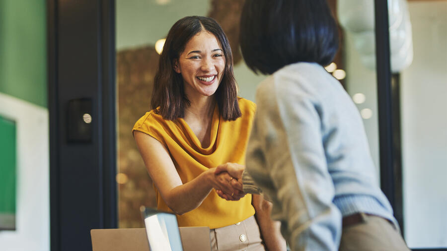 Two people meeting and shaking hands