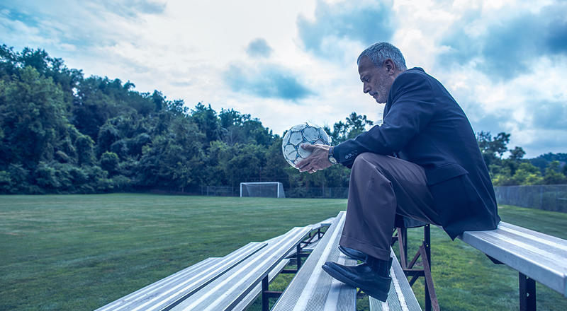 Leidos employee John Hindman holds a soccer ball that belonged to his son, Sean.