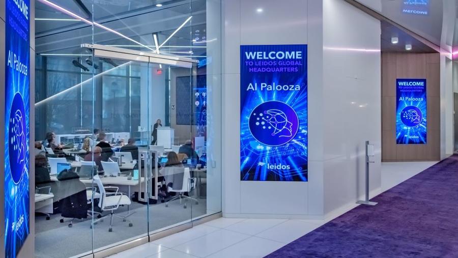 A meeting space at Leidos Global Headquarters with AI Palooza signage