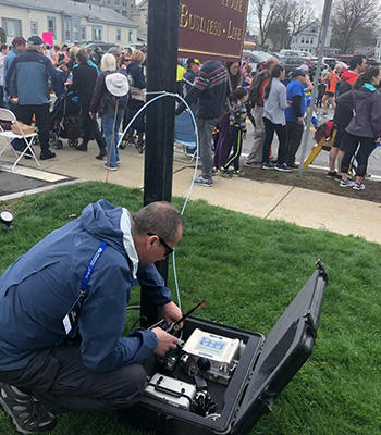Rafal Volker sets up a monitoring station at the Boston Marathon