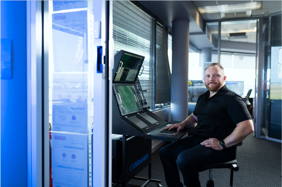 man sitting at a computer and facing the camera