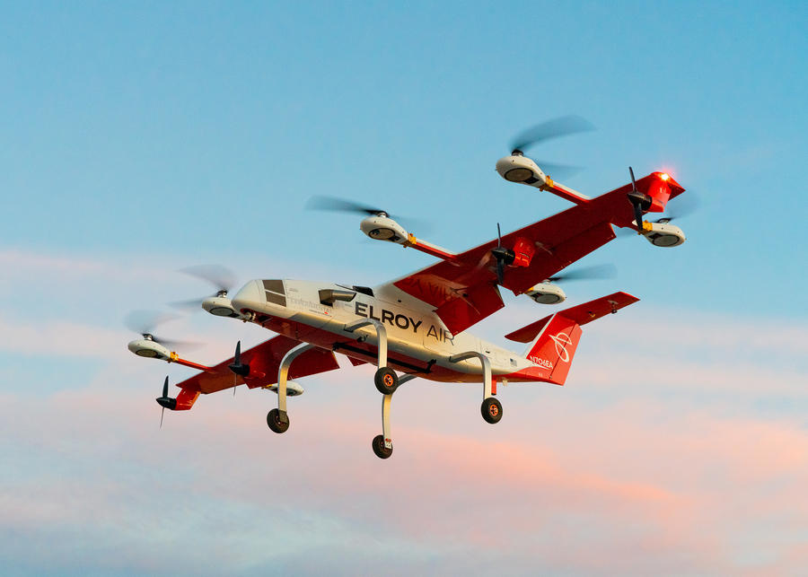 A white and orange hybrid-electric vertical take-off and landing cargo aircraft called Chaparral.