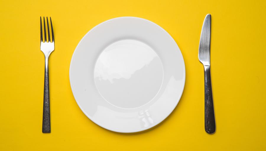 Fork, plate, and knife set with yellow background