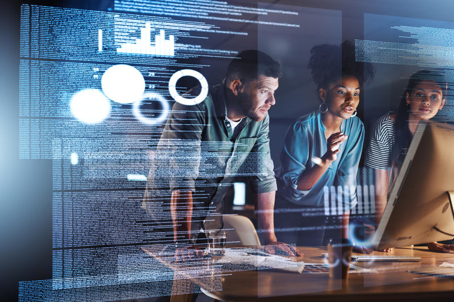 Three cybersecurity professionals looking at screen projected on a wall