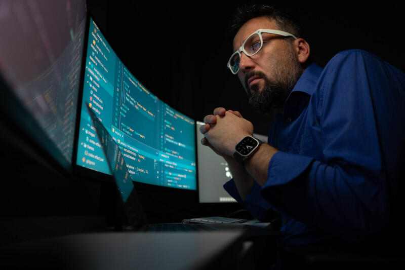 Man looking at screen of code