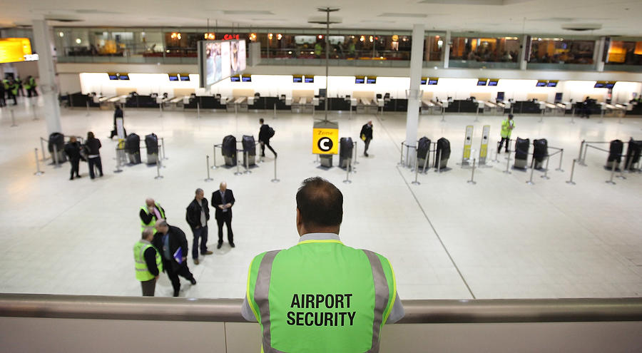 airport security male observing airport check in area