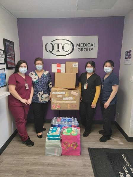 QTC Pomona Clinic employees with donation to House of Ruth