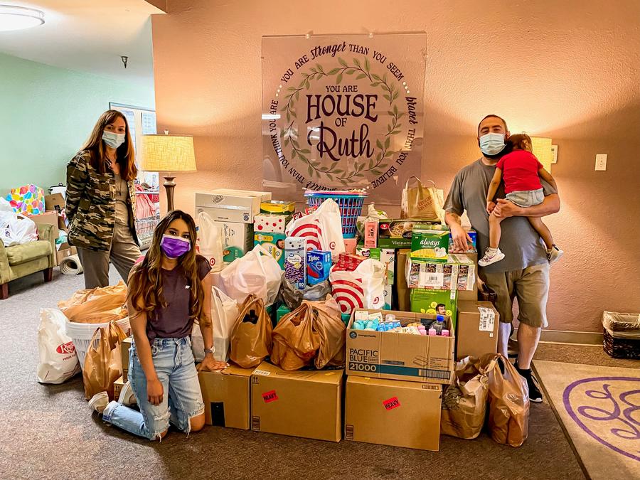 QTC volunteers inside House of Ruth with donations
