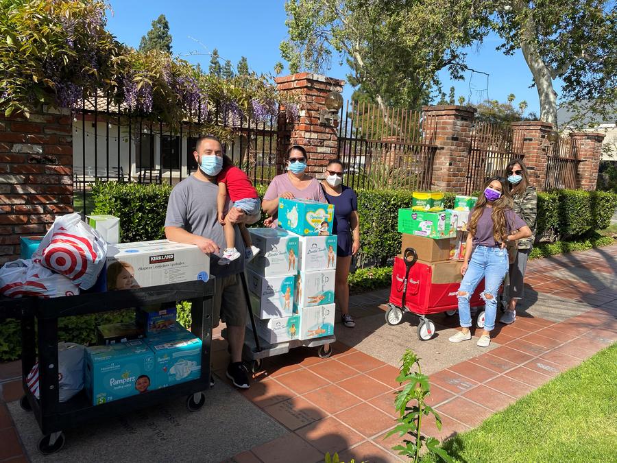 QTC volunteers outside House of Ruth with donations