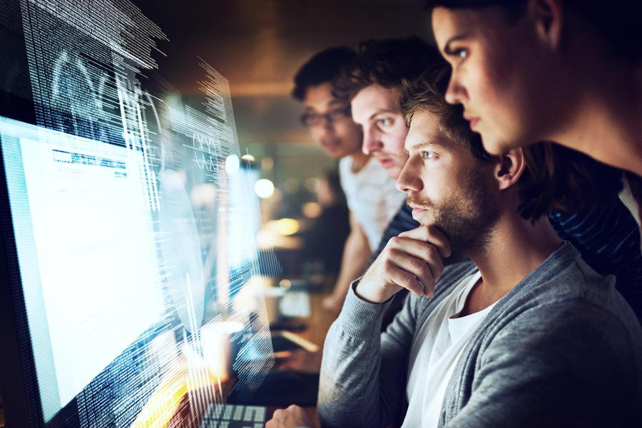 people looking at computer monitors 