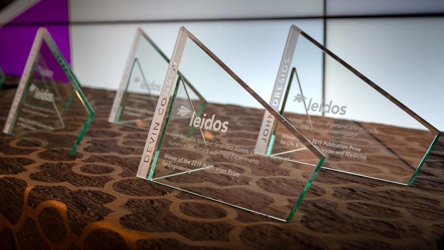 Four Leidos trophies laid out on a table