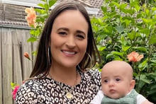 Woman holding baby outside