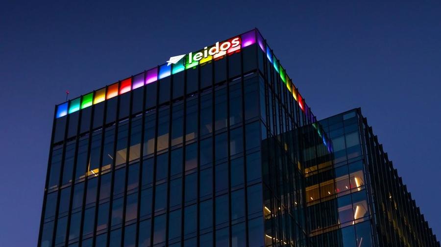 Leidos Global Headquarters at dusk lit up in the colors of the Pride flag