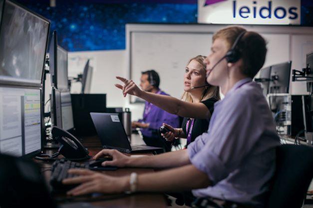 Woman pointing at computer screen 