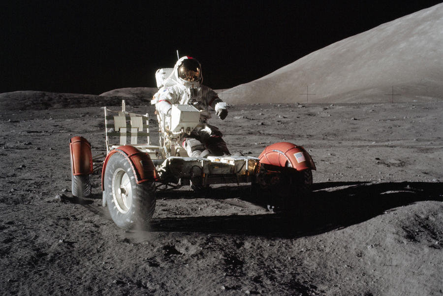 astronaut driving Lunar Roving Vehicle on the moon