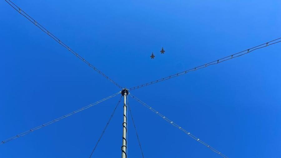 The Marine Expeditionary Long-Range Persistent Surveillance (MELPS) prototype with two fighter jets flying overhead 