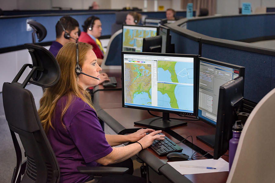 employees in a command center working on their computers in support of the FAA